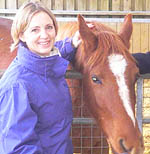 Photo of Dr Emma Batson standing next to a horse