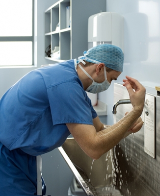 A surgeon scrubbing up for an operationtitle=