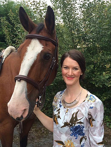 Photo of Laurie May next to a horse