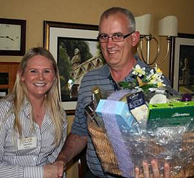 Laura Petty, Northern Region Territory Manager for Norbrook Laboratories (GB) Ltd presenting the hamper to Paul Wilson