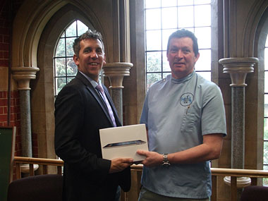 Sarah's father, Philip Lhermette, practice principal at Elands Veterinary Clinic in Sevenoaks, pictured receiving the prize on her behalf from Virbac Regional Manager Nic Chapman