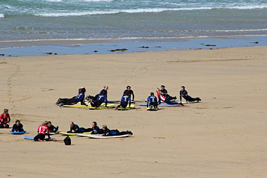Surfers having a lesson on the beach