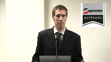 Photo of Charly Pignon standing at lectern