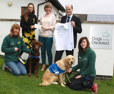 L-R Helen Bronti and assistance dog Vern, Helen Walker, Senior Product Manager for Vétoquinol, Cathryn Simpson, Corporate Partnerships Manager at Dogs for the Disabled, Martin Gough, Companion Animal Business Unit Manager at Vétoquinol and Emma Belcher and assistance dog Hayley, present a cheque and tee-shirt that has been signed and worn by Mark Colborne.
