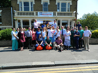 Philip Goddard (top right) presenting cheques to the charities on the completion of the relay at the Wanstead Veterinary Hospital on Thursday 26 July.