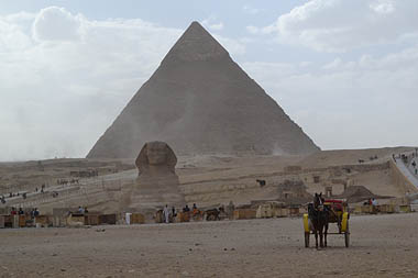 Photo of pyramids and sphinx with shanty town in foregroud
