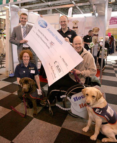 L-R; Jonny Lambert, Area Veterinary Manager, Pfizer Animal Health presents the £20,000 cheque to Hounds for Heroes volunteers, Katie Johnson, Ian Tolft (Hounds for Heroes Chairman), Allen Parton and EJ.