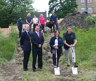 Photo of staff breaking ground