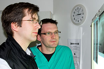 Ronan (left) and Ian (right) examine radiographs from a cat with ureteric stones prior to stent placement