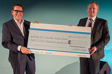 Michael Westcott holding a giant cheque