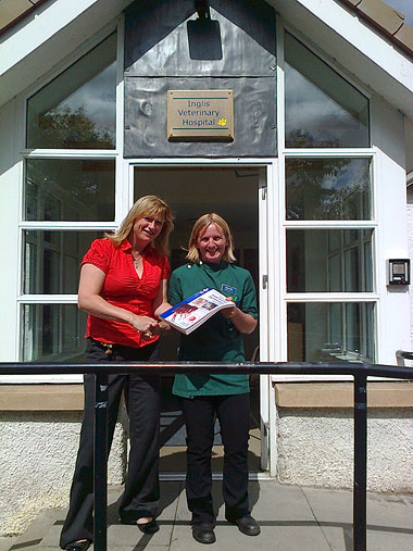 Sarah Ross being presented with a prize of the BSAVA Manual of Small Animal Dermatology by Fiona Pawson