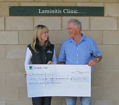 Rachel Austin of SPILLERS hands the cheque over to Robert Eustace