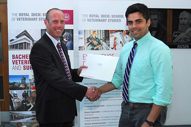 Tim Bentall, Territory Manager at Boehringer, presenting Graeme Doonauaght with his prize of a book