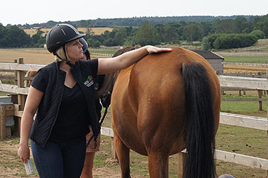 Rider patting horse on the back