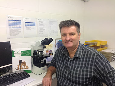 Daren sitting at his lab desk