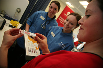 Pet Blood Bank UK nurse showing Nottingham University students the blood typing test at the recent launch of the mobile blood collection unit