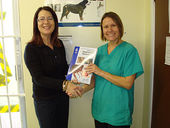 Animalcare representative, Sarah Abbott presents a manual to Pauline Sell from Bishops Stortford.