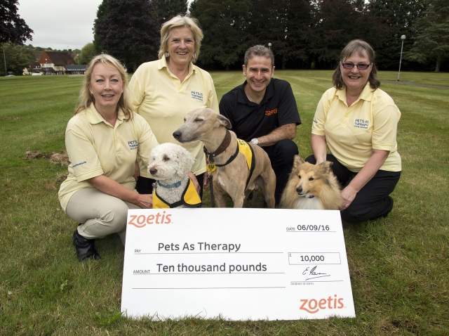Ned Flaxman from Zoetis presents a cheque to Anne Clilverd (second left), Chair of Pets as Therapy, accompanied by some of the charity's volunteers