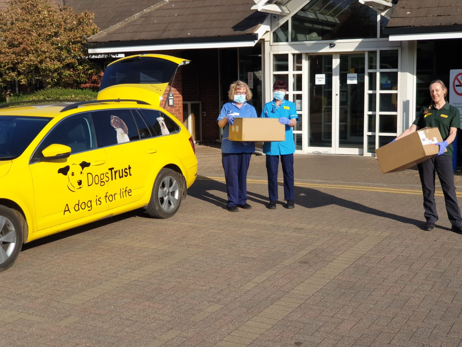 Dogs Trust Loughboroughs Kelly Smith, vet nurse assistant, handing over the medical gowns