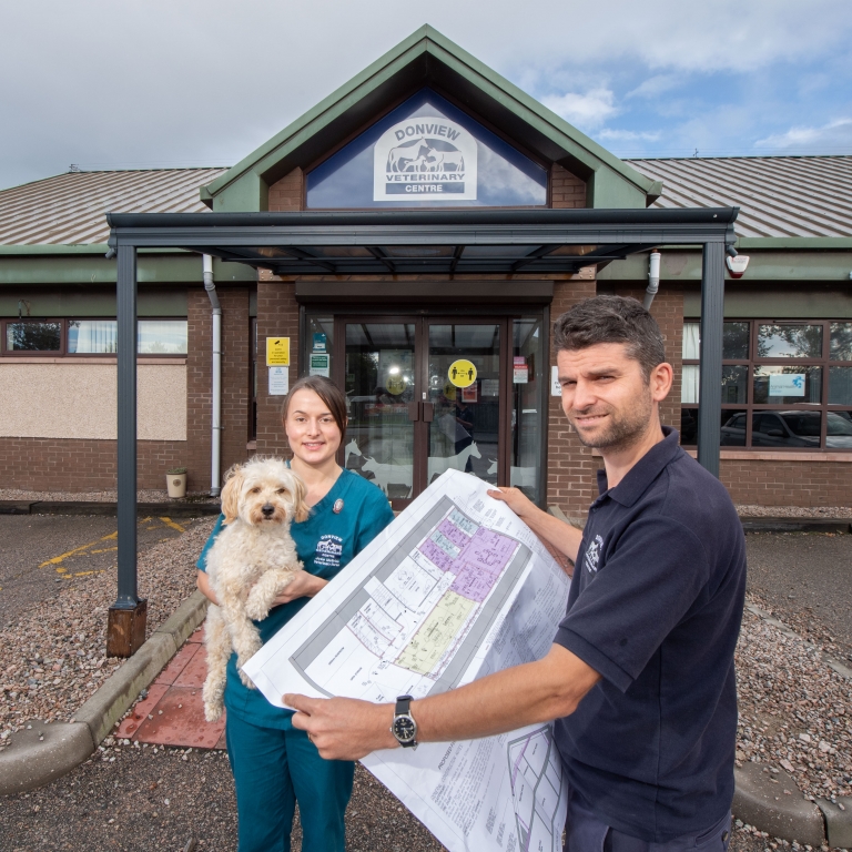 Clinical director Charlie Carnochan viewing the plans with nurse Josie McBride and dog Alfie