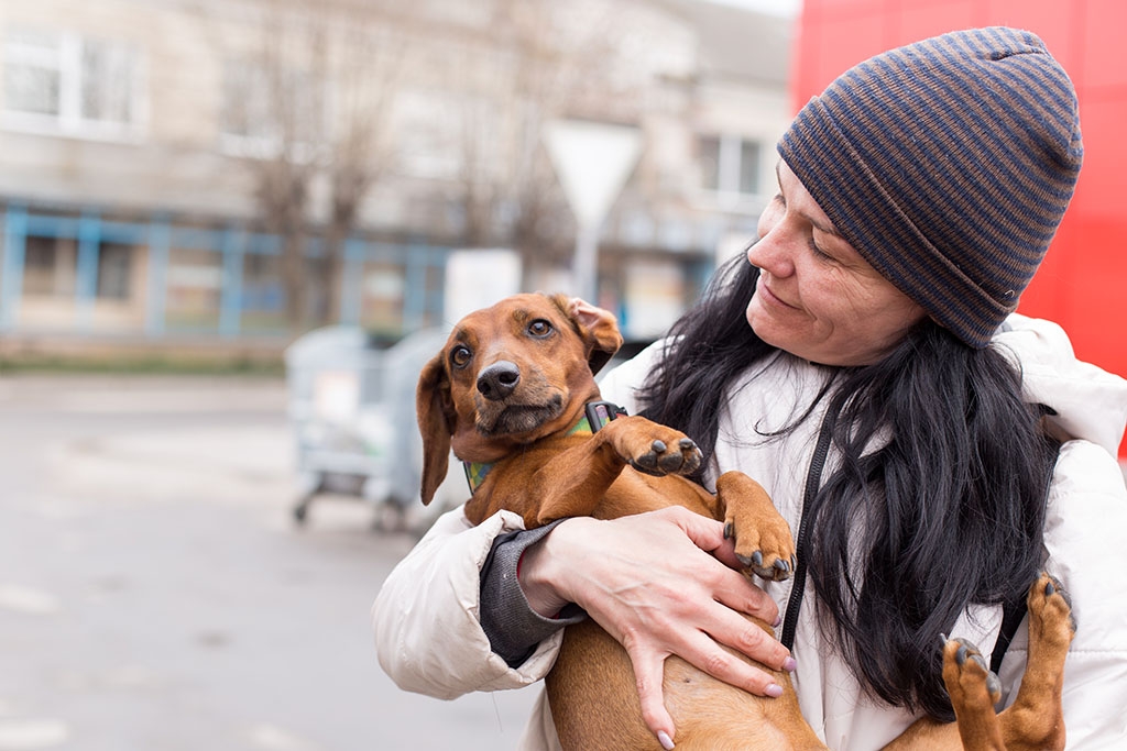 Woman holding dog in her arms