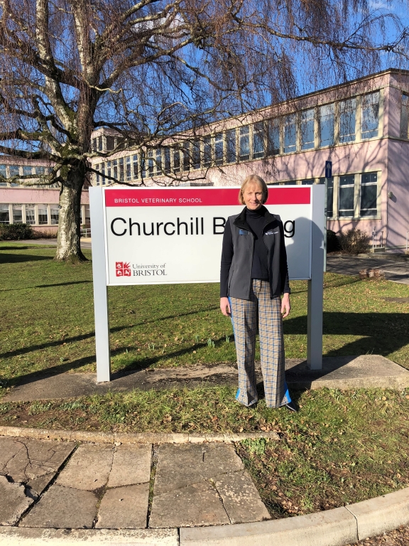 Dr Charlotte French standing in front of Churchill Building sign at Bristol Veterinary School