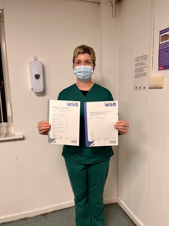 Charlotte Bunyan holding both her diplomas