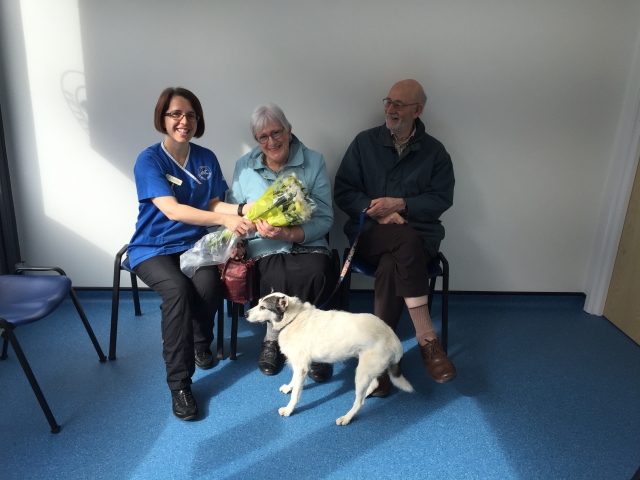 Sarah Wellstead, Clinical Director, with the practices first patient, Lucky the dog, owned by Mr and Mrs Evans, who came in for an acupuncture treatment.  Mr and Mrs Evans were presented with a bunch of flowers to mark the occasion.