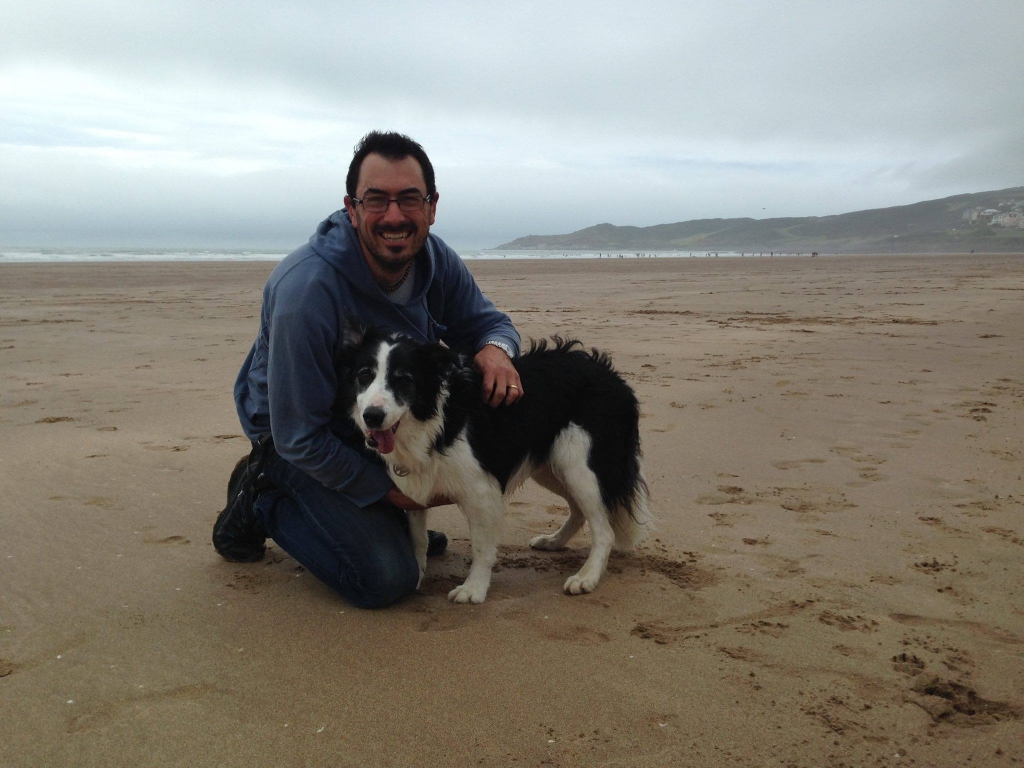 Dr Huw Stacey with his dog on the beach