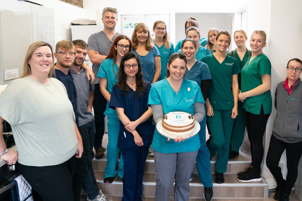Group photo of Pennard Vets staff holding a cake