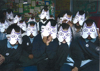 Photo of schoolkids wearing paper cat masks